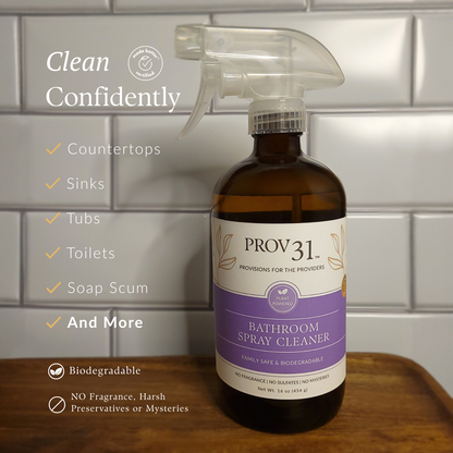 Bottle of Prov 31 bathroom spray cleaner on a wooden surface with a tiled wall background.