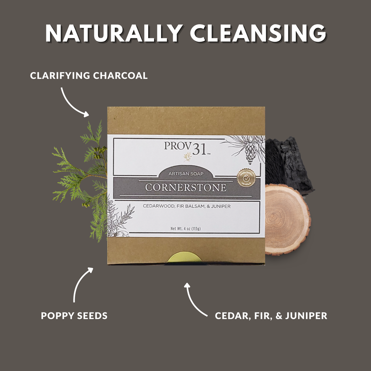 Artisan soap packaging with natural ingredients on a gray background, including charcoal, poppy seeds, cedar, fir, and juniper.