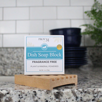Prov 31 dish soap block on a countertop next to a sink, dishes, and plant.