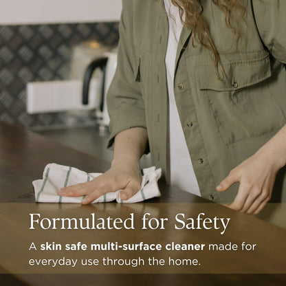 Person cleaning a surface with text about Prov 31's skin-safe multi-surface cleaner