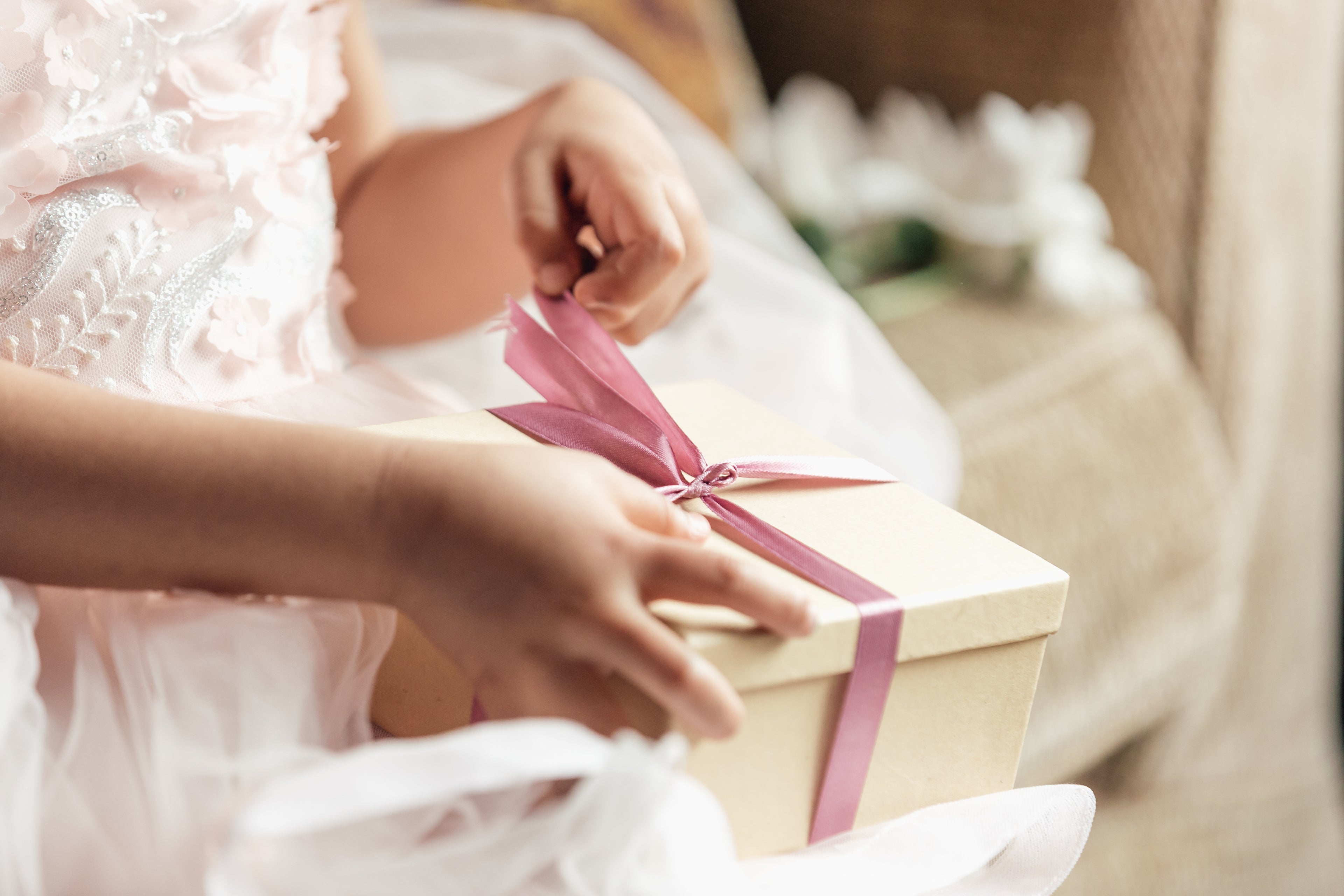 Young girl opening a gift.