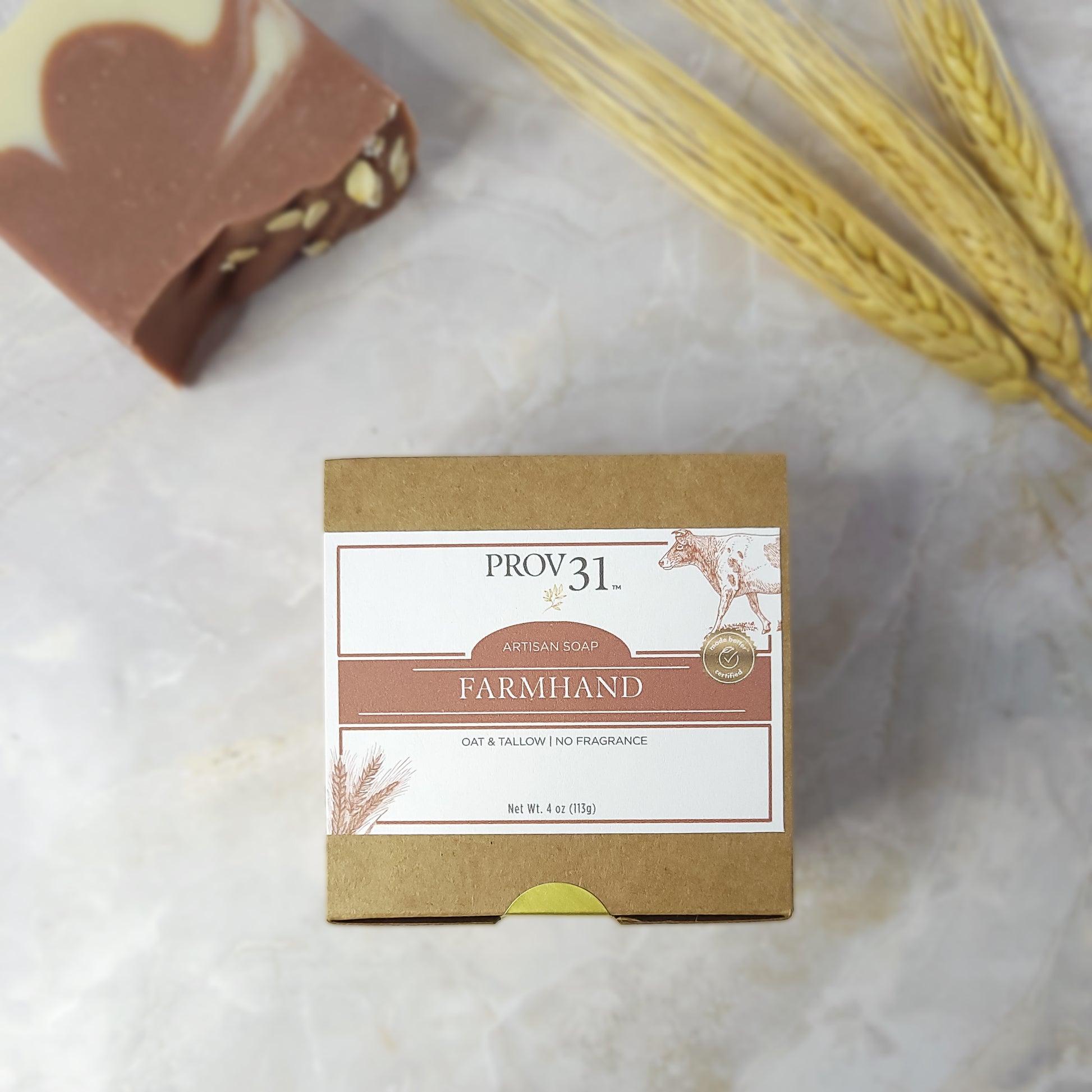 Bar of soap with a PROV 31 and oat and tallow on the packaging on a marble surface.
