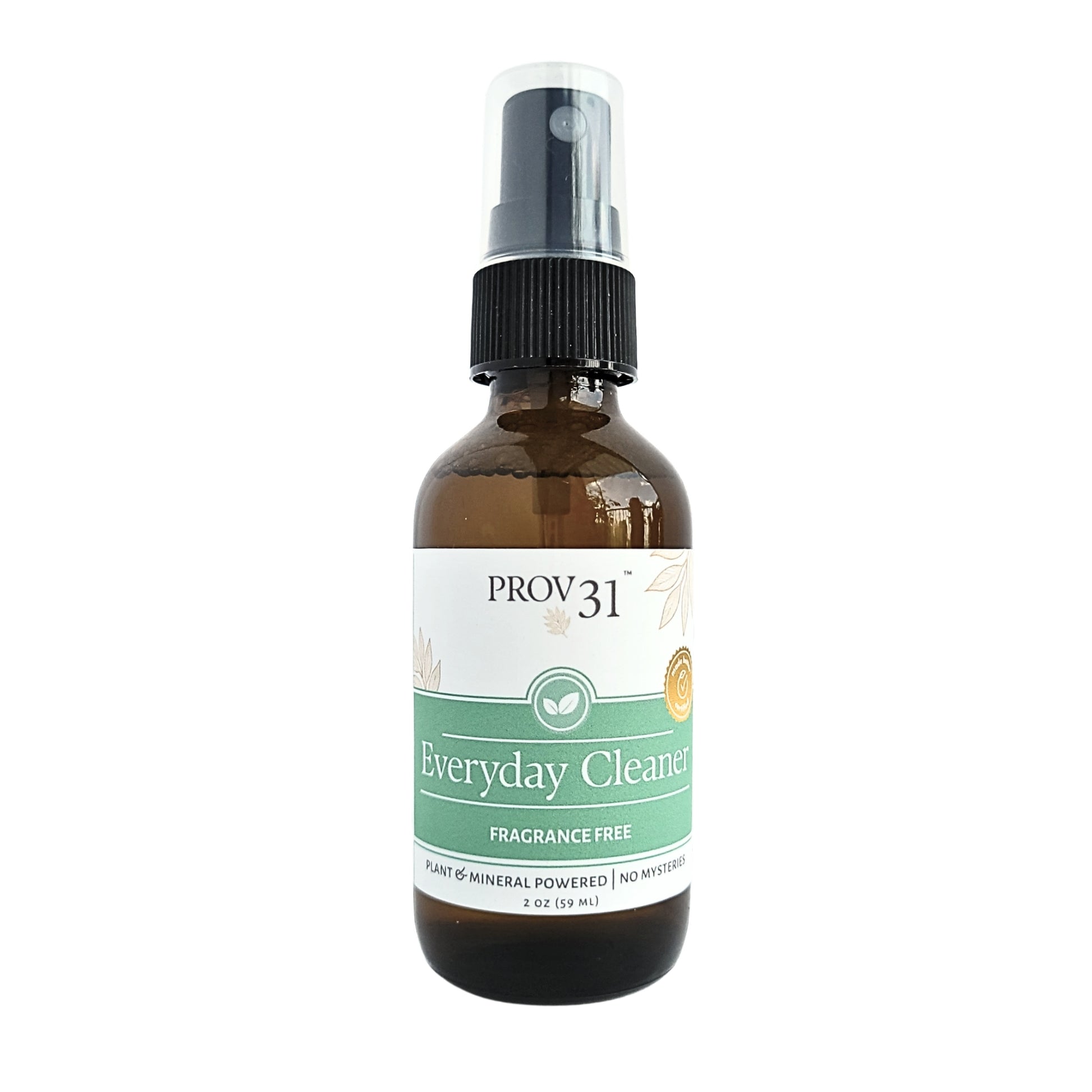 An amber glass spray bottle with a black pump dispenser and a white and green label reading 'PROV31 Everyday Cleaner Fragrance Free'.