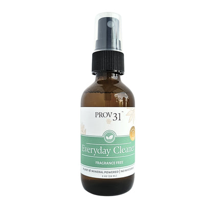 An amber glass spray bottle with a black pump dispenser and a white and green label reading 'PROV31 Everyday Cleaner Fragrance Free'.
