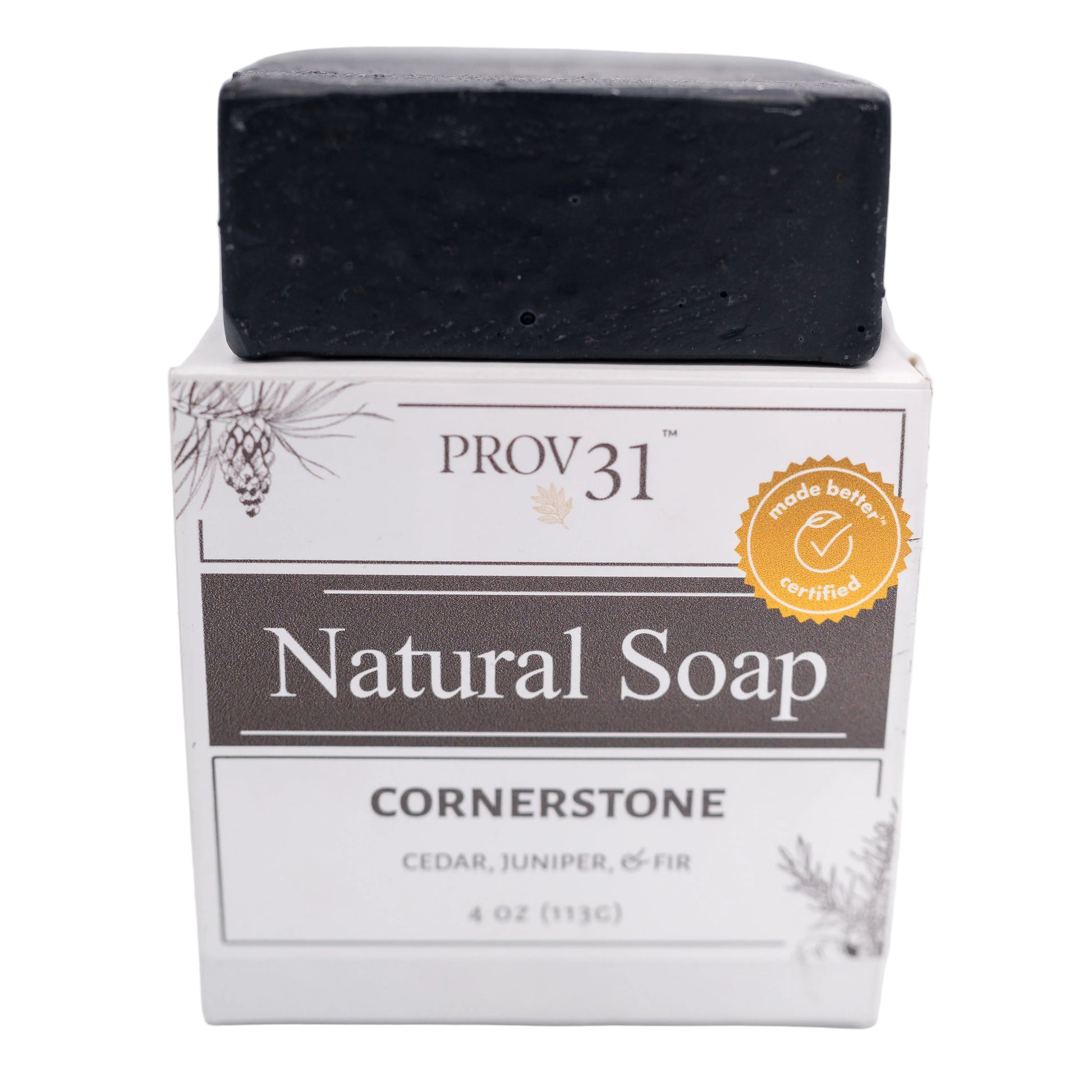 A bar of PROV 31 Natural Soap in the Cornerstone scent, made with charcoal, shown as a black rectangular bar resting on its white and gray cardboard packaging box against a white background.